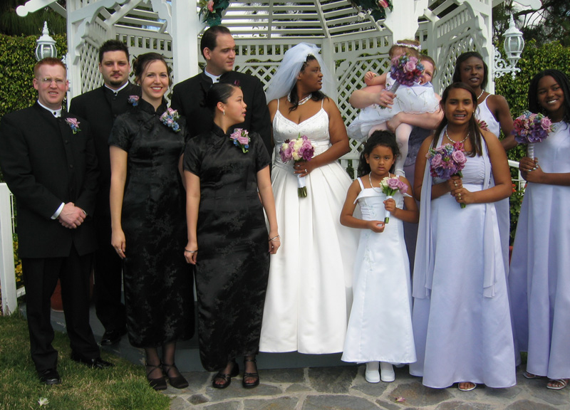 The wedding party poses for pictures outside!