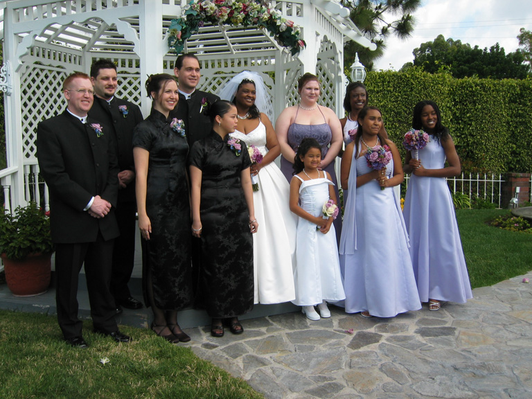 The wedding party poses for pictures outside!