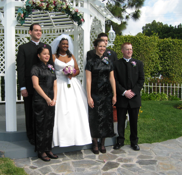 The wedding party poses for pictures outside!