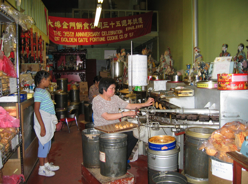 Mari watches as fortune cookies are made!