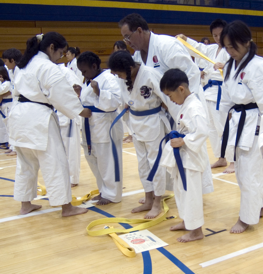 Sensei helps Mari with her blue belt!