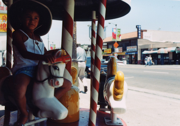 Mari tries out  a merry go round!